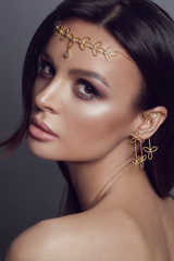 Beautiful girl in ethnic jewelry. Studio photoshoot with golden tiara - Image