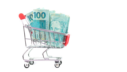 Brazilian notes one hundred (100) reais and shopping cart or supermarket trolley, business finance...