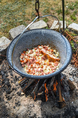 Hungarian pot over the fire bogracs during cooking the dish.