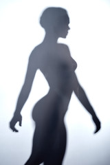 young woman with short hair walking behind the glass wall. close up photo.relaxation concept