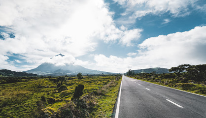 Straight EN3 longitudinal road northeast of Mount Pico and the silhouette of the Mount Pico along ,...