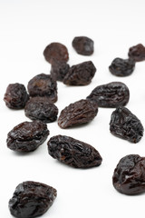 Dried plums isolated on a white background.