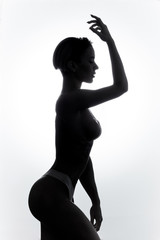 slim athlete with perfect body in stylish swimsuit doing exercsises in the morning. close up side view photo. studio shot