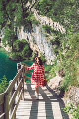 woman walking by hiking trail around braies lake in italy dolomites mountains. activity leisure lifestyle