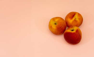 Peaches over pastel background with copy space 