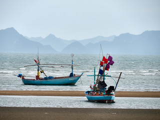 Obraz premium Two fisher boats on thai shore