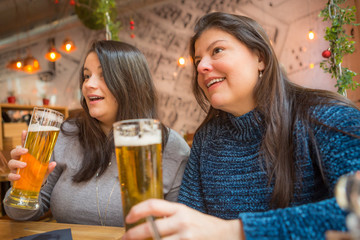 Ladies sharing a drink and food happily together