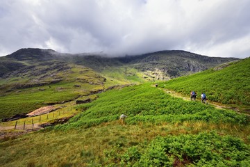 Fototapeta premium Hikers on the path upto Wetherlam