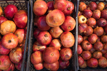 pomegranate in the fruit market. a lot of pomegranates. market. store. background. healthy food. natural food. health.VEGETARIAN. diet
