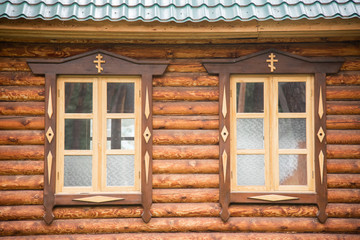 Two windows of the wooden orthodox church, Altai, Russia.