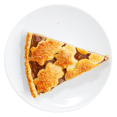 Closeup piece of homemade pie with cottage cheese and prunes on white plate. Top view. Isolated on white.