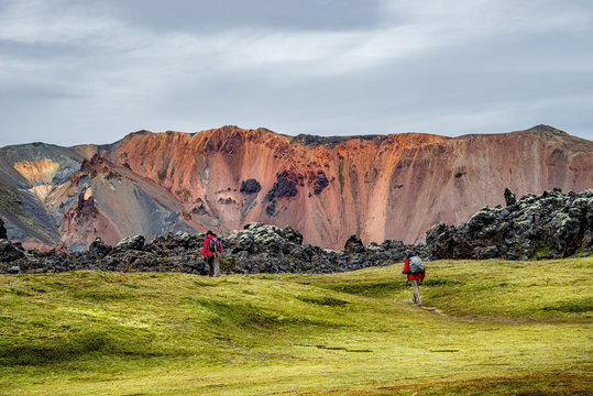 Colorful rainbow rhyolite volcanic mountains Landmannalaugar as pure wilderness in Iceland and hikers, summer time