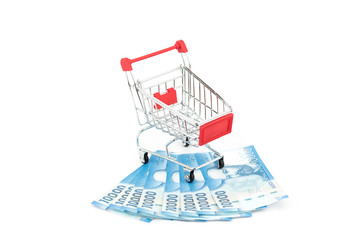 Stacks of chilean notes under shopping cart or supermarket trolley, business finance shopping...