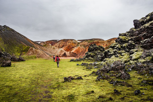 Colorful rainbow rhyolite volcanic mountains Landmannalaugar as pure wilderness in Iceland and hikers, summer time