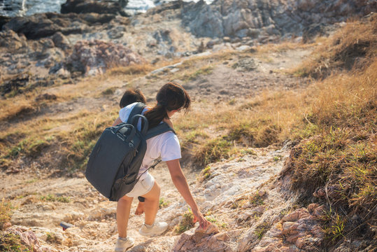 Mother Holding Son To Hiking Downhill