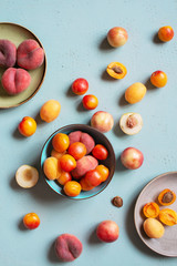 Fresh ripe tasty fruits on the textured blue table