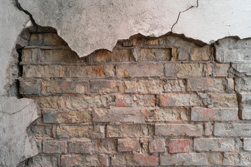 Old wall of bricks with chapped plasterwork