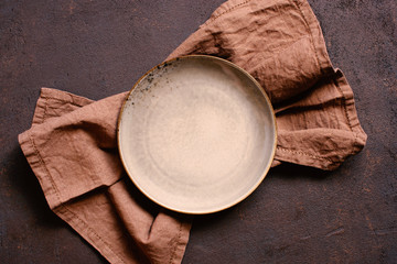Brown textured background with empty plate