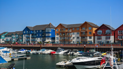 Fototapeta na wymiar Exmouth Docks, marina harbour and yachts and boats along with residential buildings, Devon, UK, June, 2019