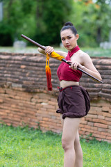 Asian woman warrior in Ayutthaya costume holding sword fight. Warrior woman of soldier of Bang...