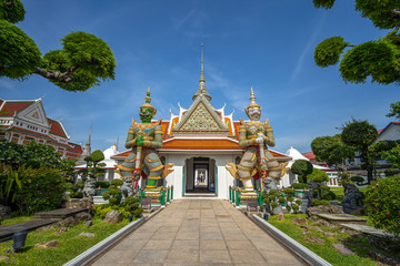 Naklejka premium Bangkok, Thailand at Wat Arun Temple, Giant Statue guarding the entrance to the temple, Bangkok, Thailand. on the Thonburi west bank of the Chao Phraya River.