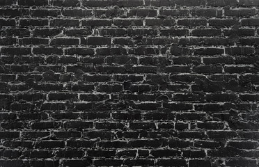 Old black painted grunge brick wall background