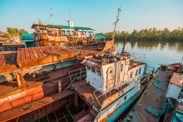 Fototapeta na wymiar Abandoned ships on the river