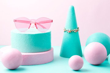 Woman accessories and geometric forms over the pink and turquoise background