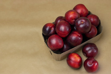 Ripe plums on a wooden background close-up. Open space, healthy food concept, plants, soil, organic natural products, natural food, vegetarian dishes, vegetables, raw, food festival