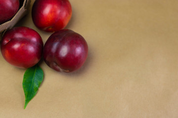 Ripe plums on a wooden background close-up. Open space, healthy food concept, plants, soil, organic natural products, natural food, vegetarian dishes, vegetables, raw, food festival