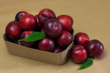 Ripe plums on a wooden background close-up. Open space, healthy food concept, plants, soil, organic natural products, natural food, vegetarian dishes, vegetables, raw, food festival