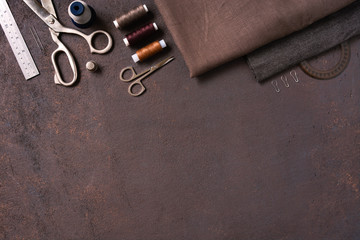 Brown textured background with sewing tools