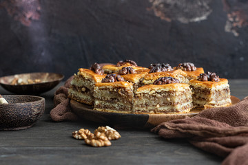 Baklava. Ramadan Dessert. Traditional Arabic dessert with walnuts and honey on a wooden table. 