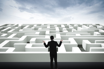 Businessman going straight ahead on a wide road between mazes