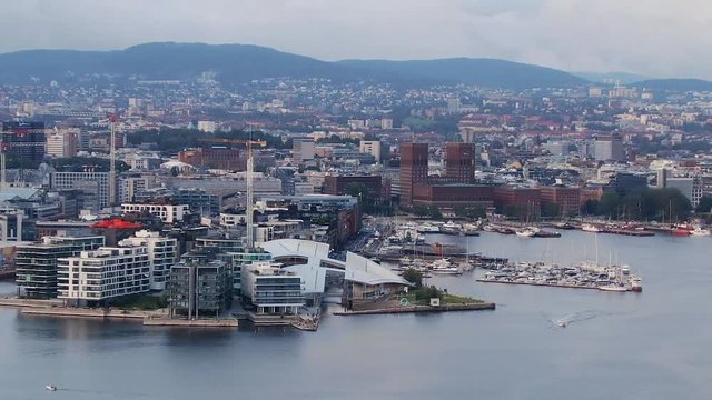 Aerial evening view towards Aker Brygge and ferries in the harbour in Oslofjord, Oslo, Norway