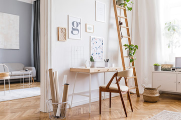 Design scandinavian home interior of open space with stylish chairs, wooden desk, plants, accessories and mock up posters gallery wall. Stylish home decor. Bright and sunny home office. Template. - obrazy, fototapety, plakaty