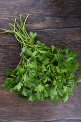 Fresh parsley on wooden table. Top view.