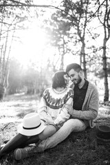 Black and white photos. Lovely hipster couple with bike . Couple wearing beautiful hats and sweaters. Lifestyle, happy couple of two play on a sunny day in the park.  Sunset in autumn. 