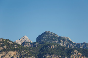 Beautiful landscape in the mountain view. Beautiful view of the Taurus mountains in the morning sun against the blue sky. Kemer, Turkey.