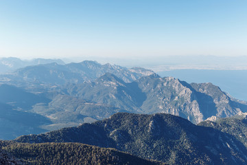 Obraz premium Beautiful landscape in the mountains. Lovely view of the Taurus Mountains and the Mediterranean coast from the top of mount Tahtali. Kemer, Turkey. Postcard view