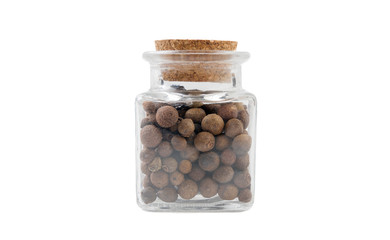 allspice jamaican pepper in glass  jar on isolated on white background. front view. spices and food ingredients.