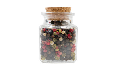 colored pepper peppercorns in glass  jar on isolated on white background. front view. spices and food ingredients.