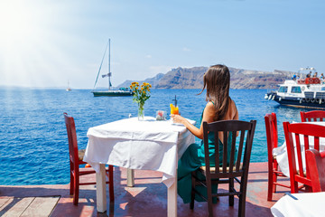 Young woman in a dress sitting at a table