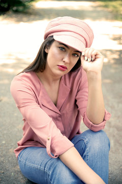 Young brunette woman sitting outdoors
