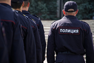 A group of Russian cops is preparing to work at the meeting. View from the back
