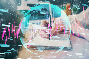 Forex chart displayed on woman's hand taking notes background. Concept of research. Double exposure