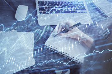 Forex chart displayed on woman's hand taking notes background. Concept of research. Multi exposure