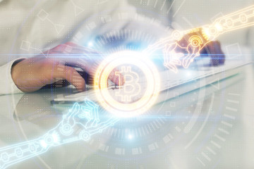 Crypto currency theme hologram with businessman working on computer on background. Concept of...