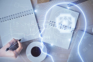 Multi exposure of woman's writing hand on background with brain hologram. Concept of brainstorming.