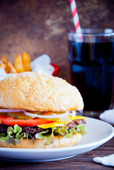 Homemade burger, Fries and Cold drink on wooden background